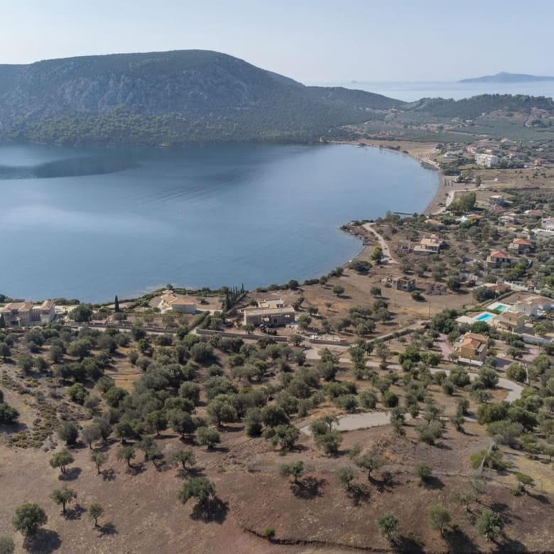 Drone view of the coastline and bay with open sea views, Ermioni, Greece