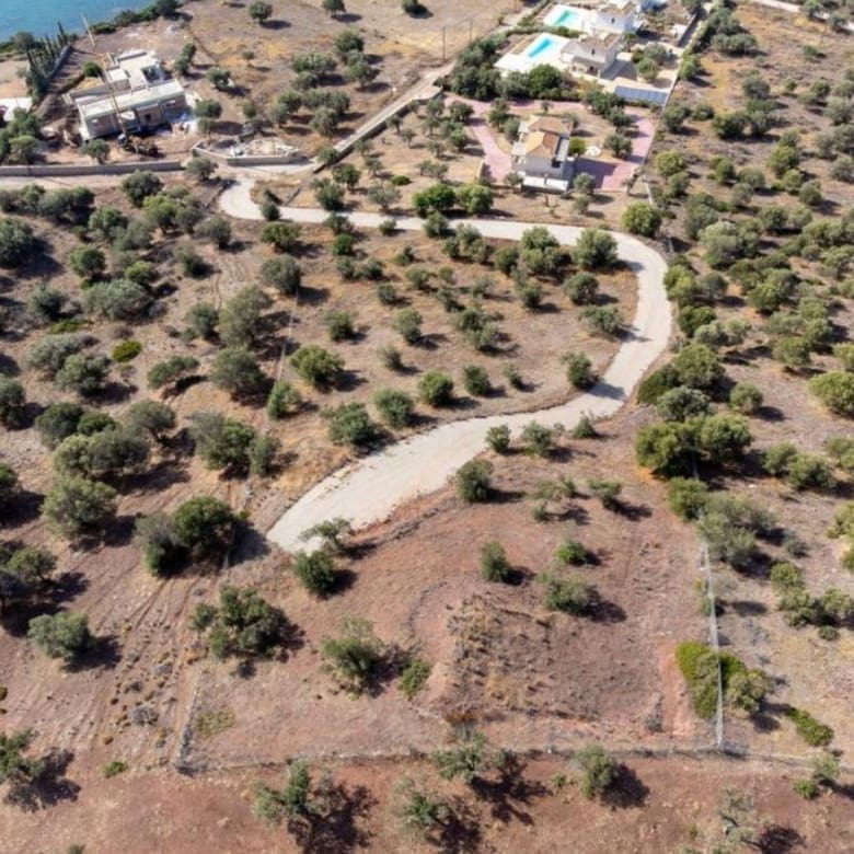 Drone view of the plot area with road access and nearby residences, Ermioni, Greece