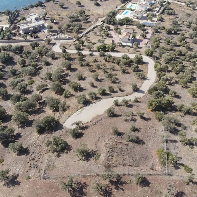 Drone view of the land plot with access road and surrounding terrain, Ermioni, Greece