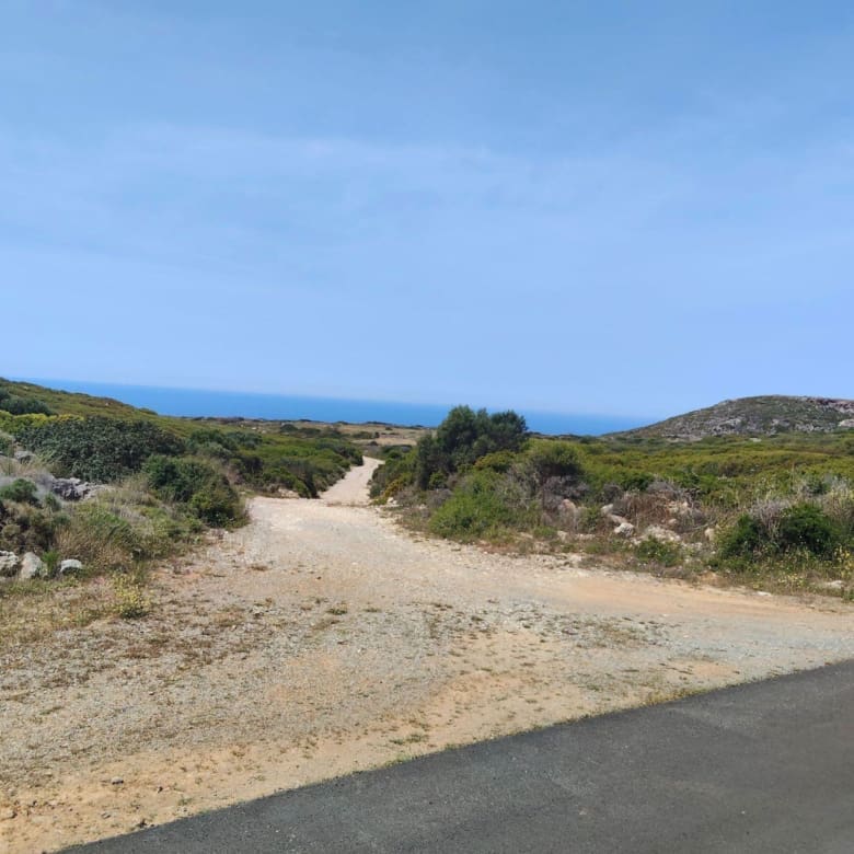 Access road and dirt track with distant sea horizon, Kythira, Greece