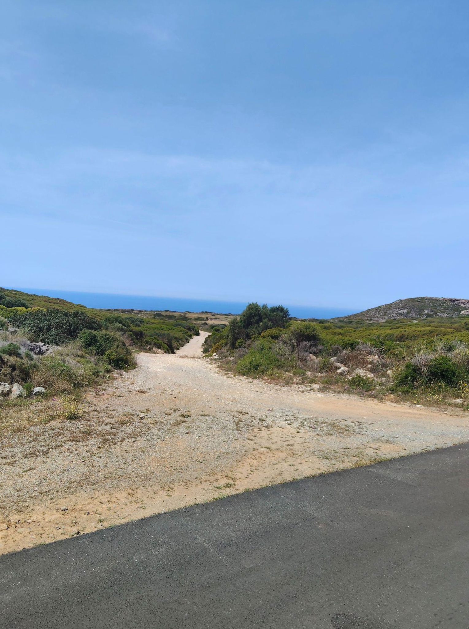 Access road and dirt track with distant sea horizon, Kythira, Greece