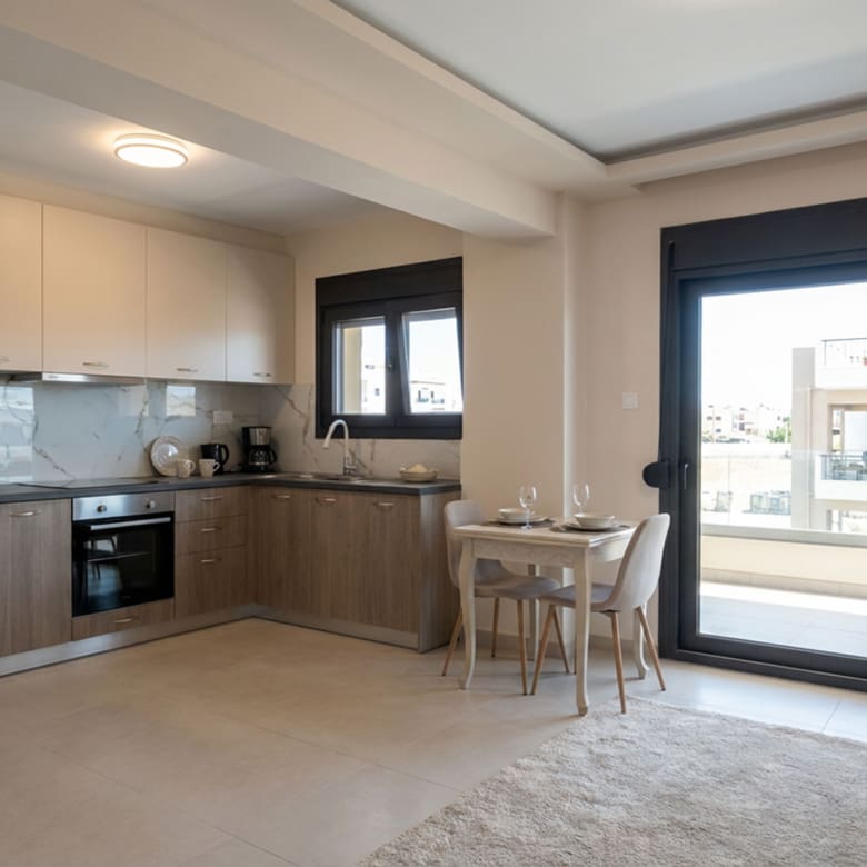 Newly built open-plan kitchen and dining area with balcony access in a duplex maisonette in Nea Ionia, Volos