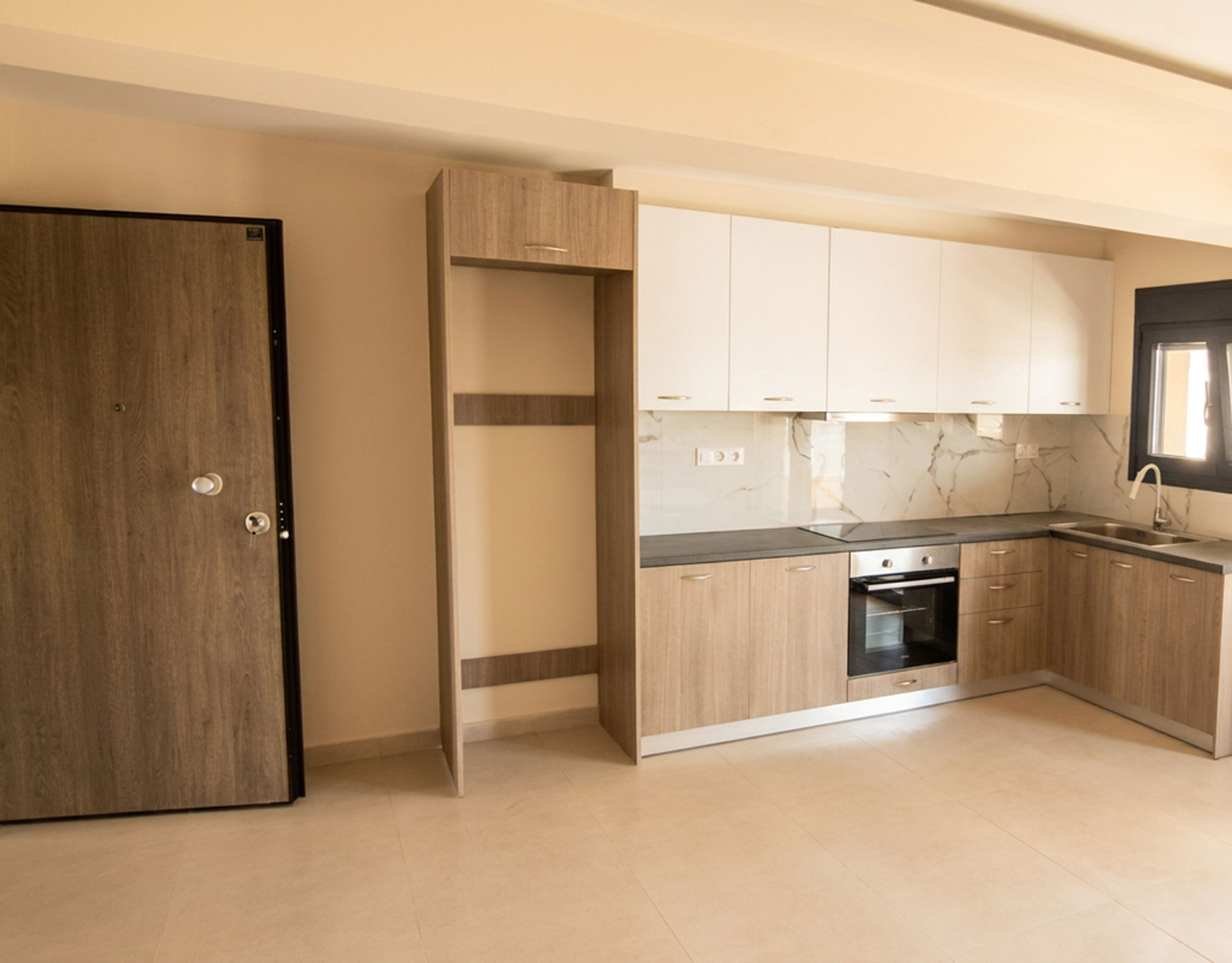 Modern Fitted Kitchen & Entrance Area Modern fitted kitchen with built-in oven and security entrance door in a newly built duplex maisonette in Nea Ionia, Volos
