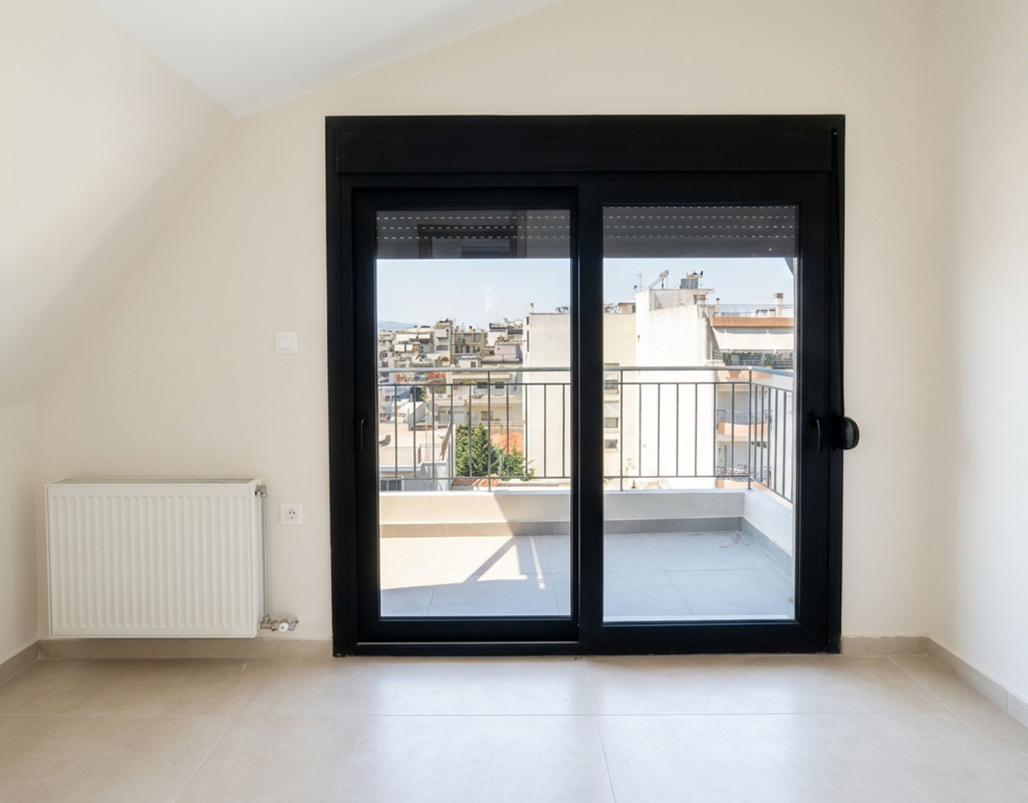 Bright Room with Balcony Access Bright room with balcony doors and city view in a newly built duplex maisonette in Nea Ionia, Volos