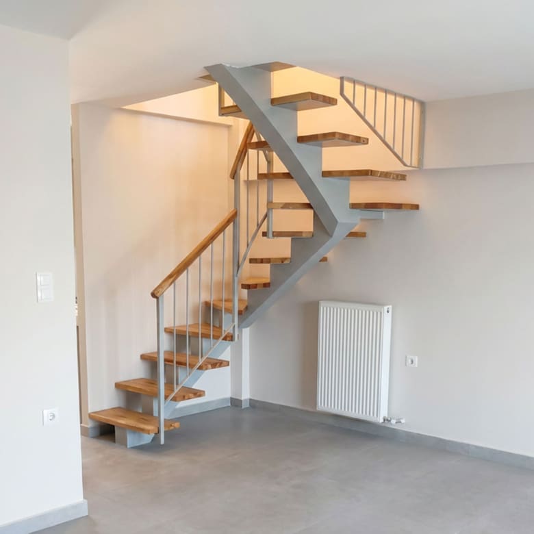 Internal wooden staircase connecting the two levels of a newly built duplex maisonette