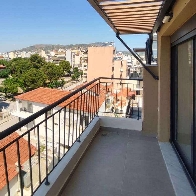 Spacious balcony with pergola shading and open city views from a newly built duplex maisonette in Volos