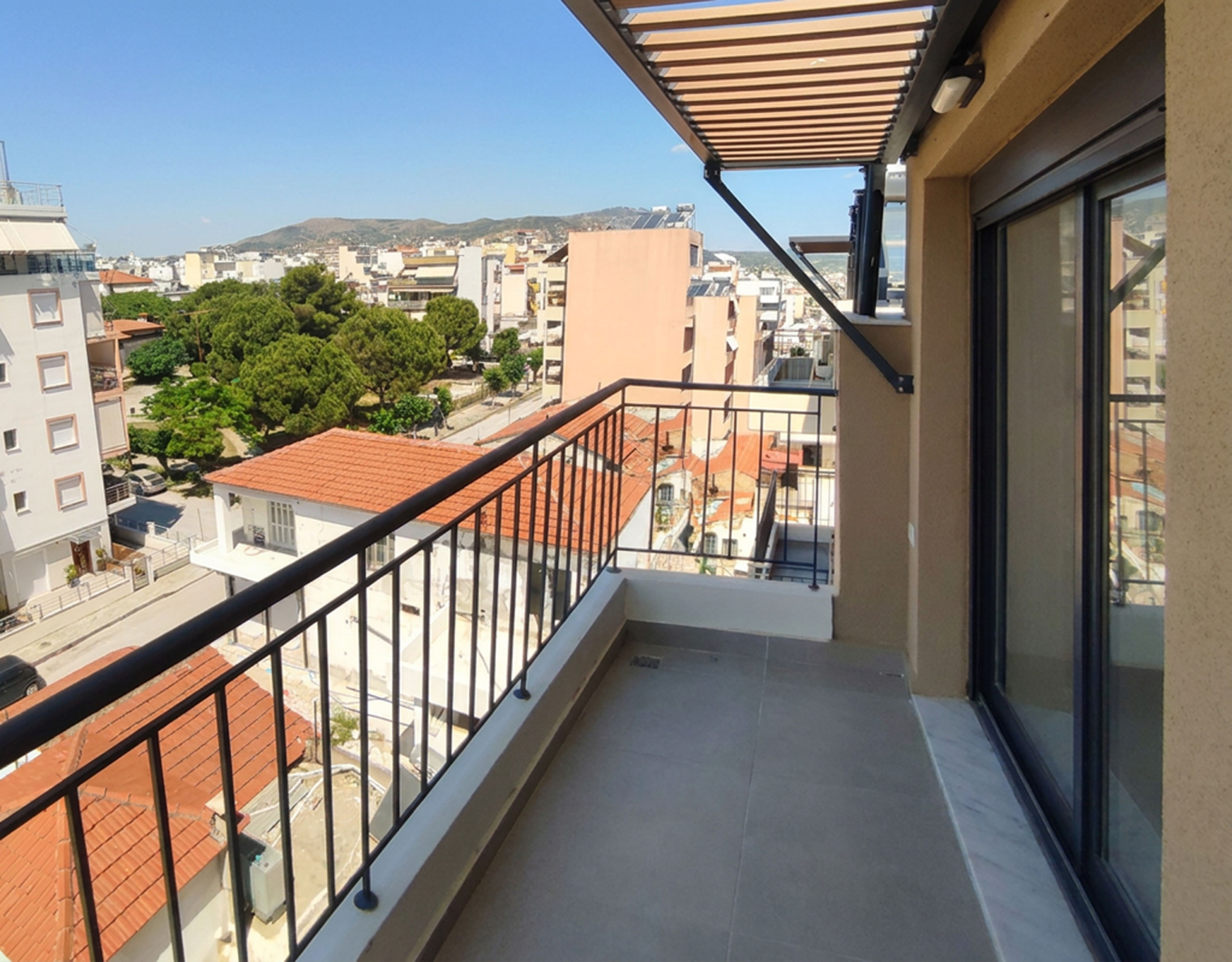 Spacious Balcony with Pergola & Views Spacious balcony with pergola shading and open city views from a newly built duplex maisonette in Volos