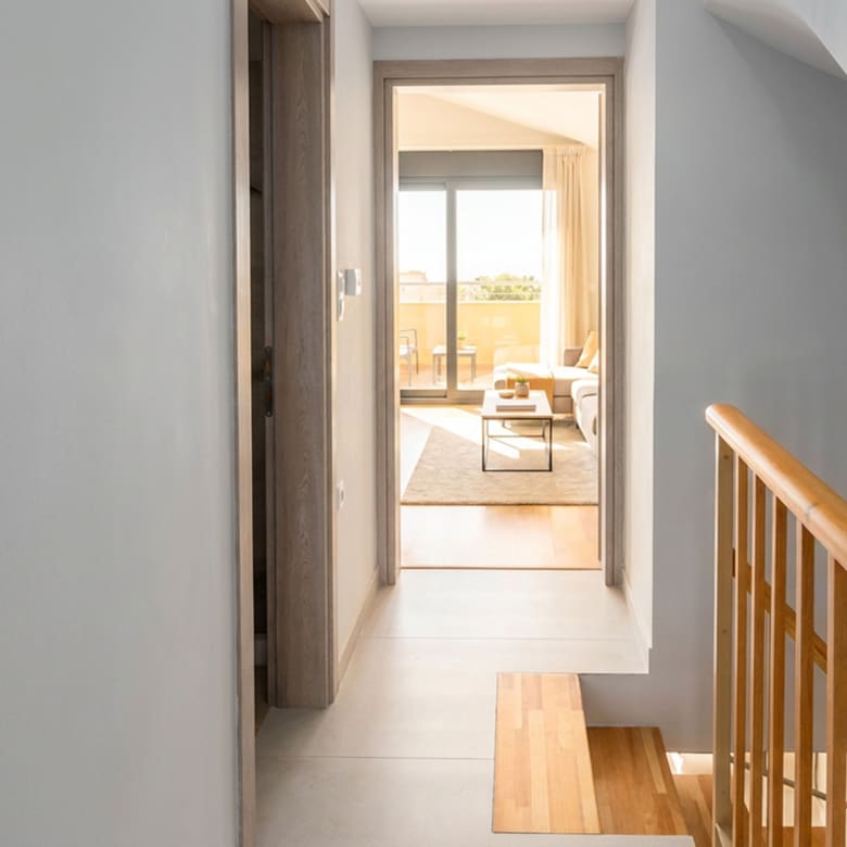 Upper-floor hallway leading to a living area with balcony doors (virtual staging, indicative layout)