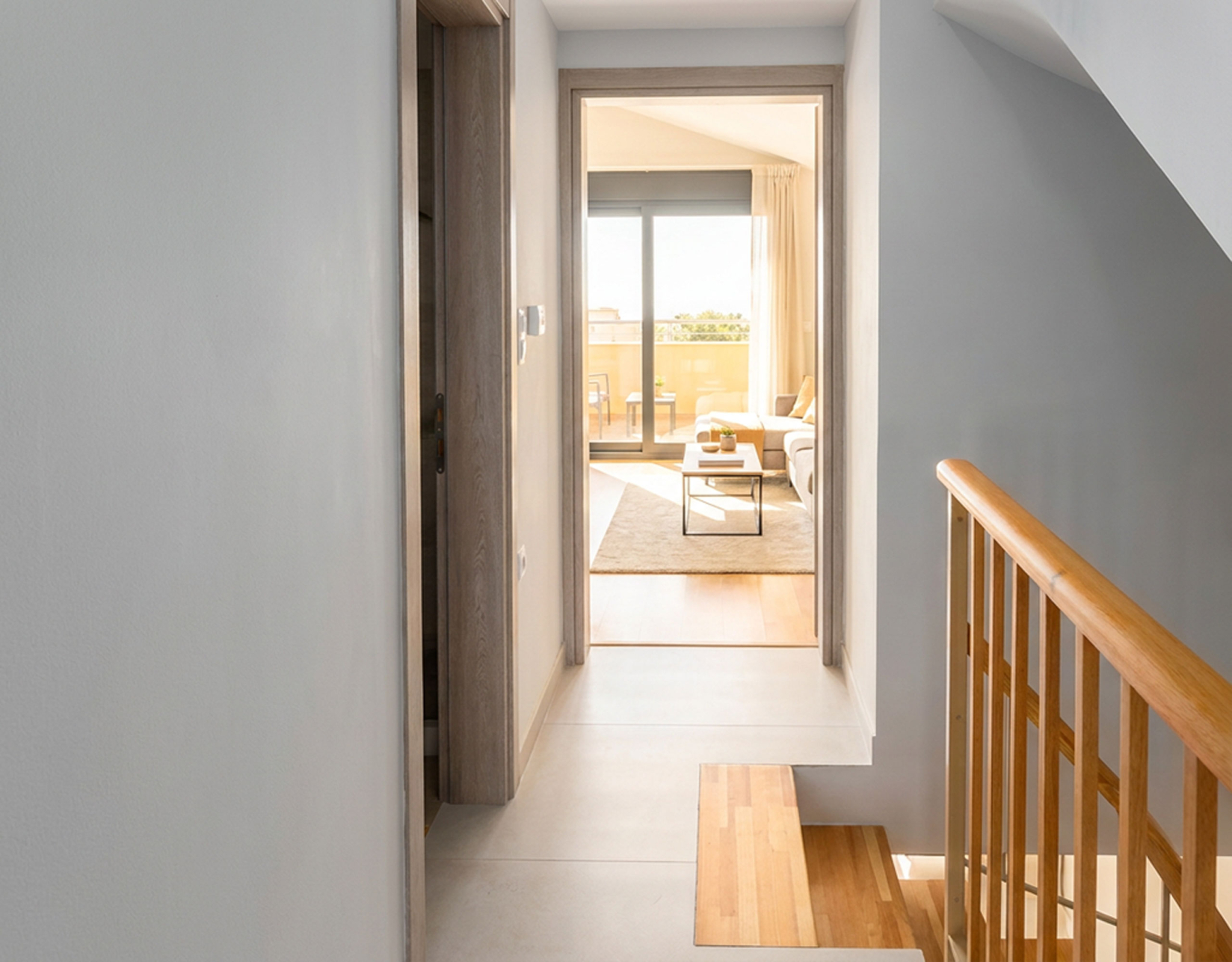 Upper-Floor Hallway (Virtual Staging) Upper-floor hallway leading to a living area with balcony doors (virtual staging, indicative layout)