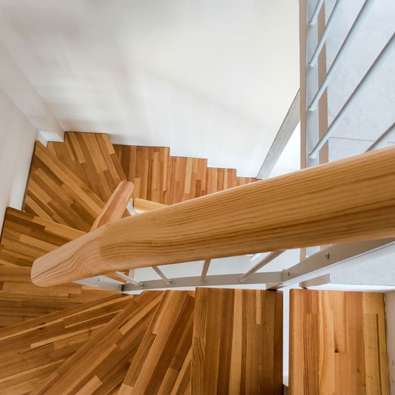Top view of the internal wooden staircase connecting the two levels of a duplex maisonette
